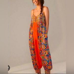 Anthropologie Vega romper.  Orange with multi colored flowers.  Size small.